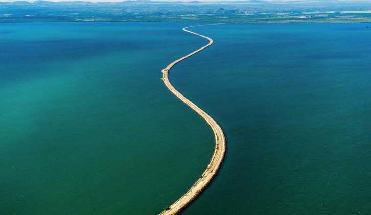 The causeway traverses small islands while preserving marine and terrestrial biodiversity.