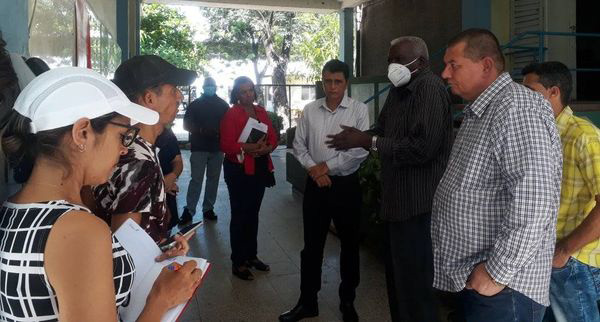 Esteban Lazo talks with workers and irectors of the Majibacoa Sugar Company