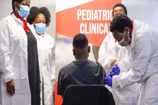 A healthcare worker administers a SINOVAC Covid-19 vaccine on a minor during the Numolux/SINOVAC Paediatric Covid-19 Vaccine Clinical Trial at the Sefako Makgatho Health Sciences University in Pretoria, on September 10, 2021.