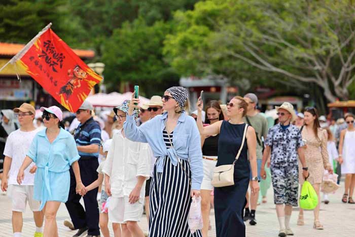 Foreign tourists visit the Nanshan Cultural Tourism Area in Sanya, south China’s Hainan province, July 23, 2025.