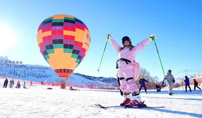 An influencer poses for a picture at the Jiangjunshan International Ski Resort in Altay.