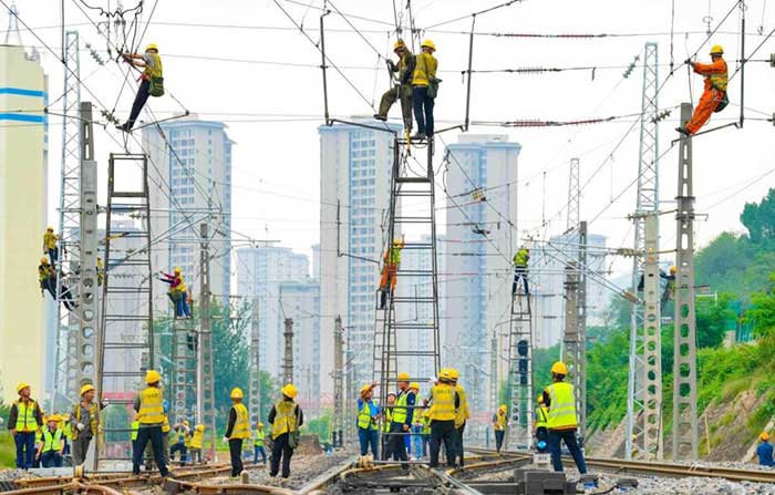 Technicians inspect a bullet train at a maintenance facility in Zhengzhou, central China's Henan province. 