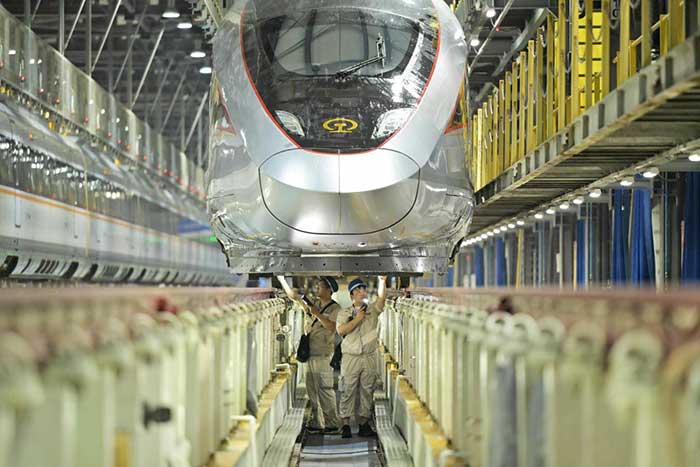 Technicians inspect a bullet train at a maintenance facility in Zhengzhou, central China's Henan province.