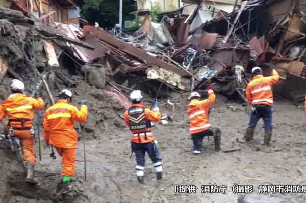 Firefighters conduct search and rescue operations at a mudslide site in Atami. Some 1,500 people are combing the mud for survivors Photo: Shizuoka City Fire Department - Fire and Disaster Management Agency via Reuters