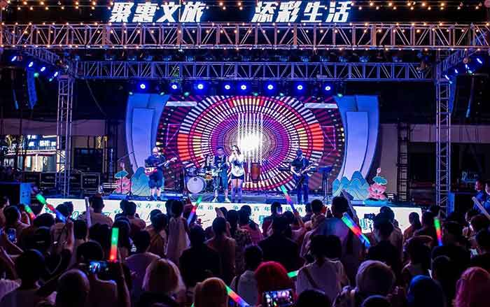 A music festival is held in a commercial area in Honghu, August 10, 2024.
