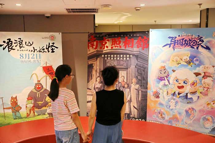 Citizens watch film posters in a cinema in Nanhu district, Jiaxing, east China's Zhejiang province, July 28, 2025.