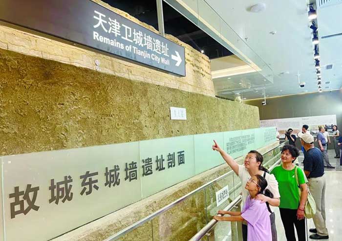 Citizens visit the exhibition hall featuring the remains of Tianjin's ancient eastern city wall at the Dongnanjiao Station of Tianjin Metro Line 4.